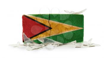 Brick with broken glass, violence concept, flag of Guyana