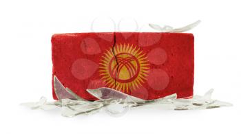 Brick with broken glass, violence concept, flag of Kyrgyzstan