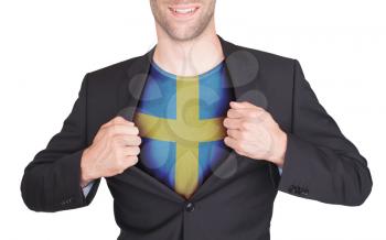 Businessman opening suit to reveal shirt with flag, Sweden