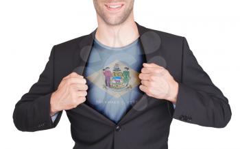 Businessman opening suit to reveal shirt with state flag (USA), Delaware