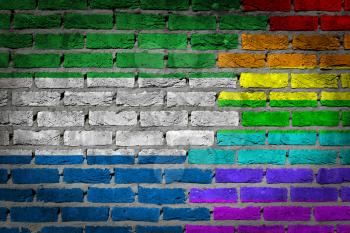Dark brick wall texture - coutry flag and rainbow flag painted on wall - Sierra Leone