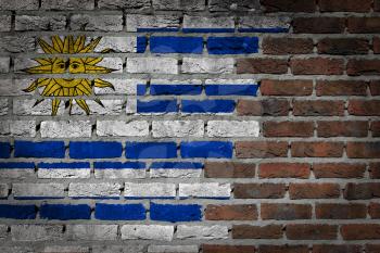 Very old dark red brick wall texture with flag - Uruguay