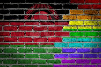Dark brick wall texture - coutry flag and rainbow flag painted on wall - Malawi
