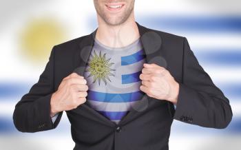 Businessman opening suit to reveal shirt with flag, Uruguay
