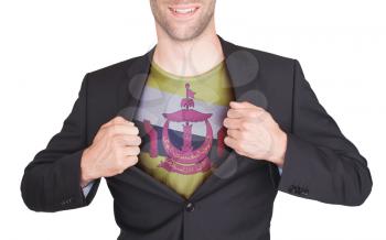 Businessman opening suit to reveal shirt with flag, Brunei