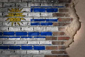 Dark brick wall texture with plaster - flag painted on wall - Uruguay