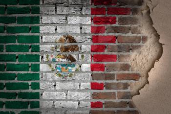 Dark brick wall texture with plaster - flag painted on wall - Mexico