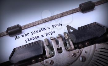 Vintage inscription made by old typewriter, He who plants a tree, plants a hope