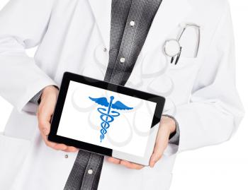 Doctor holding tablet, isolated on white - Caduceus symbol