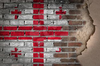Dark brick wall texture with plaster - flag painted on wall - Georgia