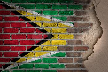 Dark brick wall texture with plaster - flag painted on wall - Guyana
