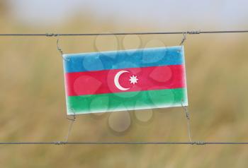 Border fence - Old plastic sign with a flag - Azerbaijan