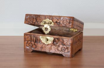 Very old wooden chest with simple lock, selective focus