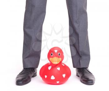 Businessman with black shoes, red ducky in the middle, isolated on white