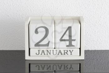 White block calendar present date 24 and month January on white wall background