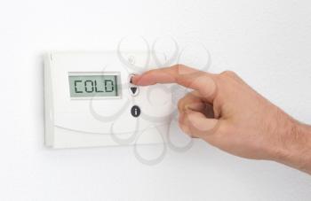 Vintage digital thermostat - Cold - Man adjusting the temperature