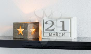White block calendar present date 21 and month March on white wall background