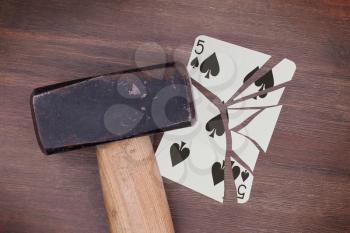 Hammer with a broken card, vintage look, five of spades