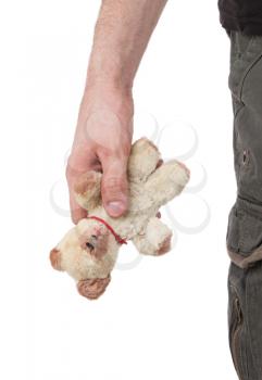 Very old teddybear in the hand of a man