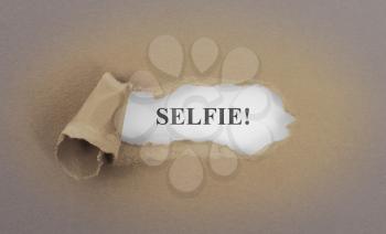 Text appearing behind torn brown envelop - Selfie