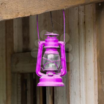 Old pink lantern in a wooden shed