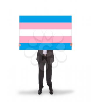 Smiling businessman holding a big card, flag of Trans Pride, isolated on white