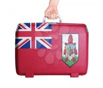 Used plastic suitcase with stains and scratches, printed with flag - Bermuda