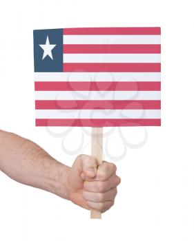 Hand holding small card, isolated on white - Flag of Liberia
