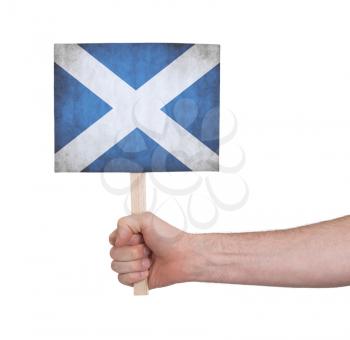 Hand holding small card, isolated on white - Flag of Scotland