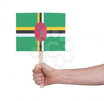 Hand holding small card, isolated white - Flag of Dominica