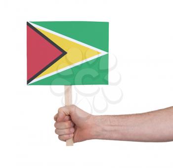 Hand holding small card, isolated on white - Flag of Guyana