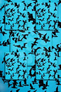 Set of black silhouettes of birds on a blue background
