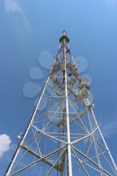 high telecom tower on the background of blue sky