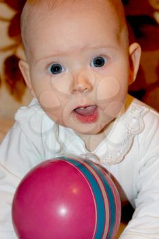 beautiful little baby playing with red ball