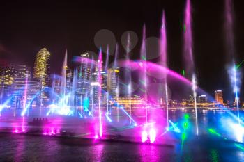 SINGAPORE - JUNE 23, 2018: Fountains night laser show in Singapore near Marina Bay Sands hotel at summer night