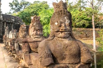 Row of sculptures in the Gate of in complex Angkor Wat in Siem Reap, Cambodia in a summer day