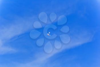 Photo of flying military airplane in blue sky
Photo of flying military airplane in blue sky with bird