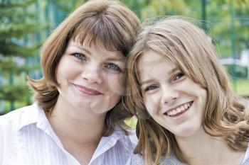 Happiest mother and daughter fourteen years old in summer time