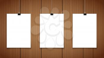 Set of 2 blank posters hanging on a thread with black clipsagainst a wooden wall as a minimalistic style portfolio, gallery presentation concept. 3d illustration