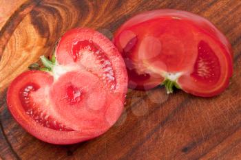 red tomato on wooden board