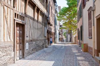 small medieval street with half-timbered houses in in Troyes, France