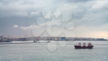 ship in Bosporus gulf and Istanbul view in overcast day