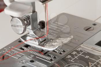 thread in needle of sewing machine closeup