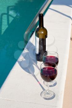 bottle and two glasses with red wine outdoor