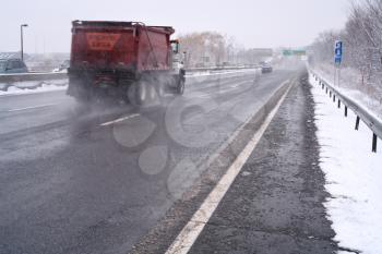truck on highway in snowy day