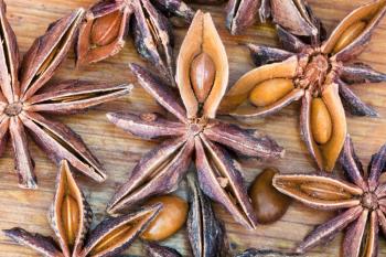 macro view of Anise tree star seeds on wooden table