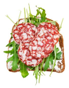 sandwich from rye bread, cottage cheese, salami and rocket salad isolated on white background
