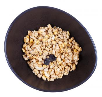 top view of dried muesli with raisin and nuts in black bowl