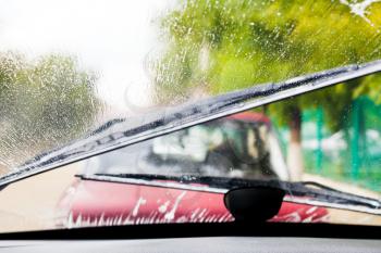 Car wipers clean windshield when driving in rain