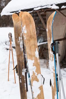 wide wooden hunting skis and log house in winter day